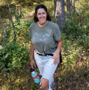 Photo of Jerica Fehr, standing in wooded area